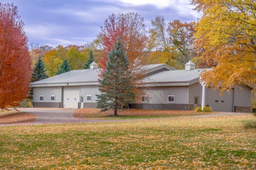 Massive pole building with a 60x90 cold storage section and a 42x45 heated portion offering a bathroom, 12ft exterior doors, and prep work done for in-floor heat.