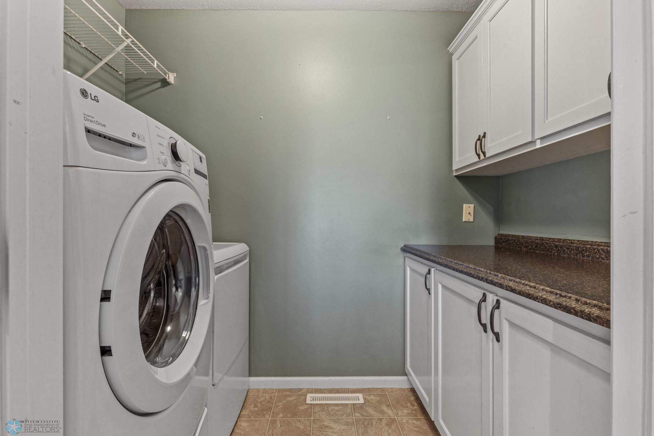 Main Level Laundry Room w/ Cabinets