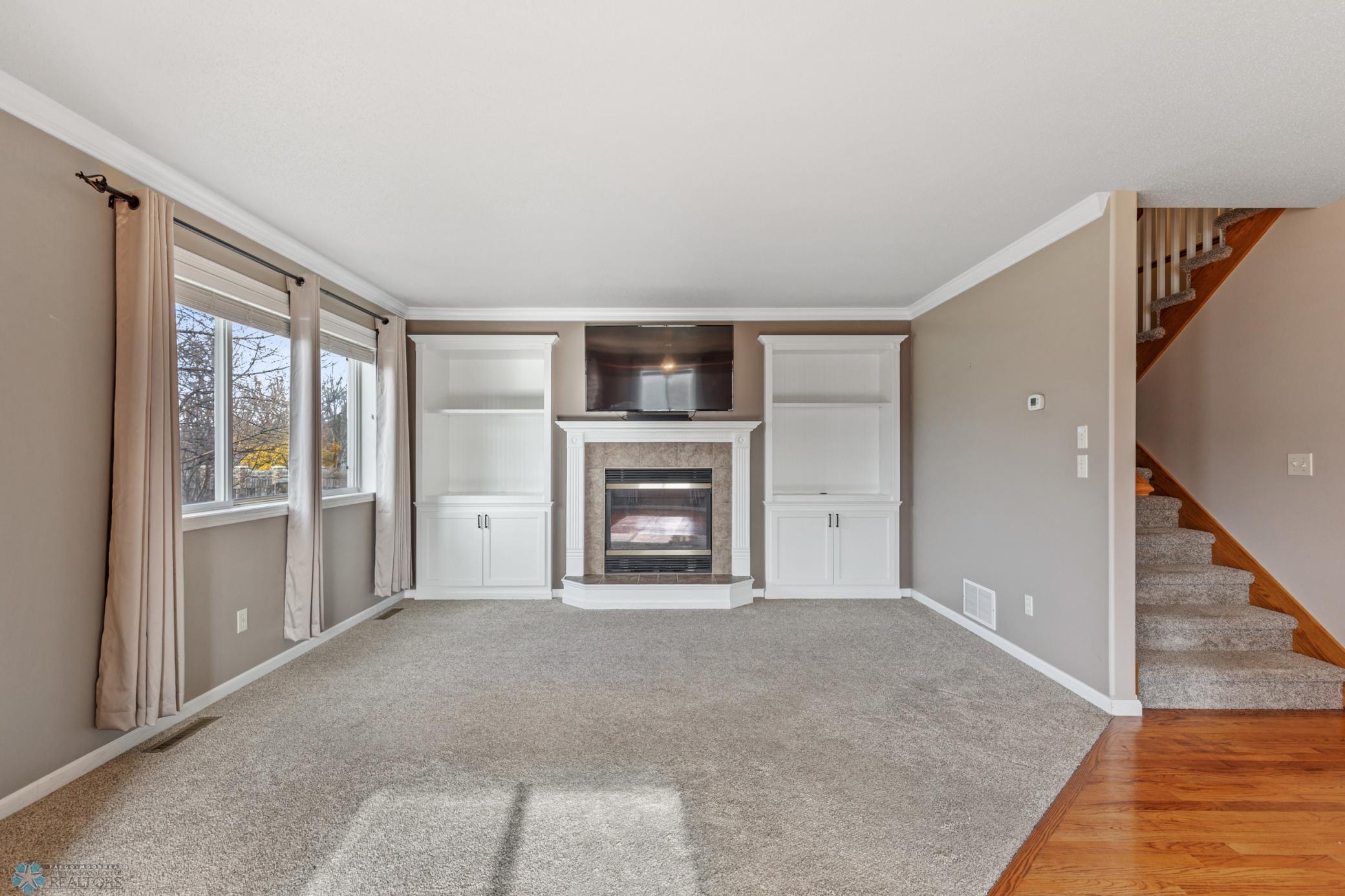 Living Room w/ Gas Fireplace & Built-In Cabinets