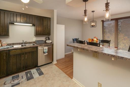 Open Kitchen w/Breakfast Bar & Pendulum Lighting