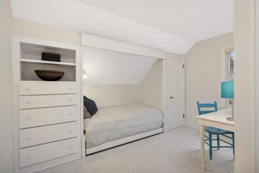 Another darling bedroom upstairs features a a cozy alcove daybed, and a unique window pass-through that opens for a spacious feel or closes for privacy.