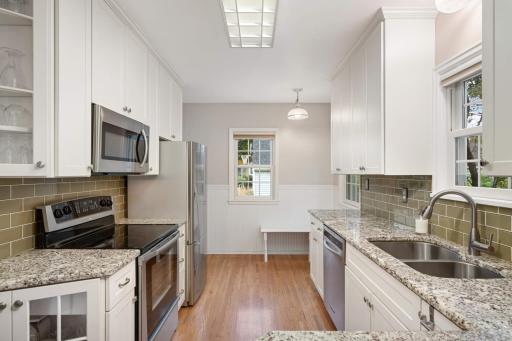 This kitchen features granite countertops, beautiful cabinetry, and excellent workspace for everyday living and entertaining.
