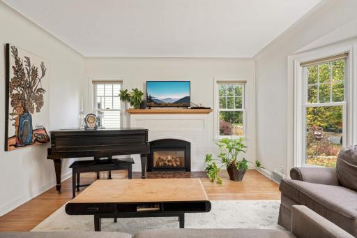The living room is anchored by a cozy gas fireplace.