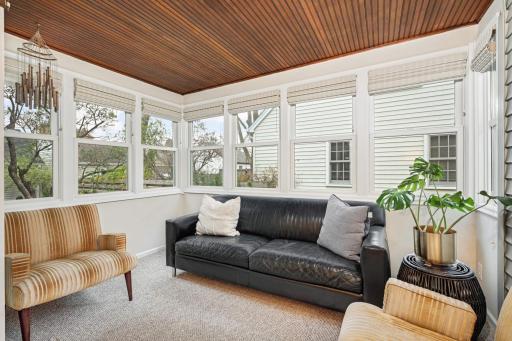 A sun-filled 4 season porch offers the perfect place to enjoy your morning coffee, unwind with a book, or gather with friends while overlooking the lush landscaping.