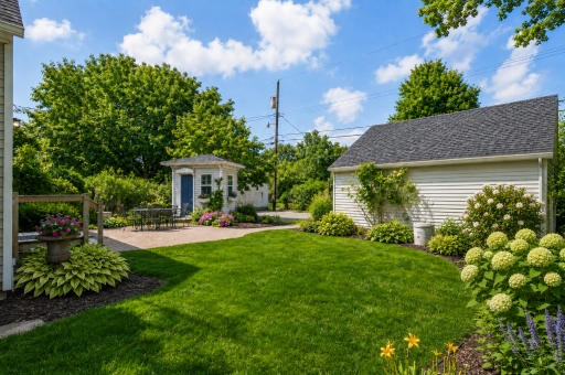 You'll love the darling cottage-style structure ideal for a potting shed or play house stepping directly onto a spacious patio for alfresco dining amid lush landscaping.