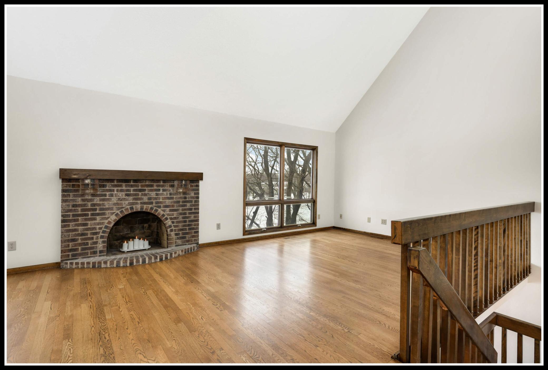 The living room picture window looks out to the backyard and lakeshore