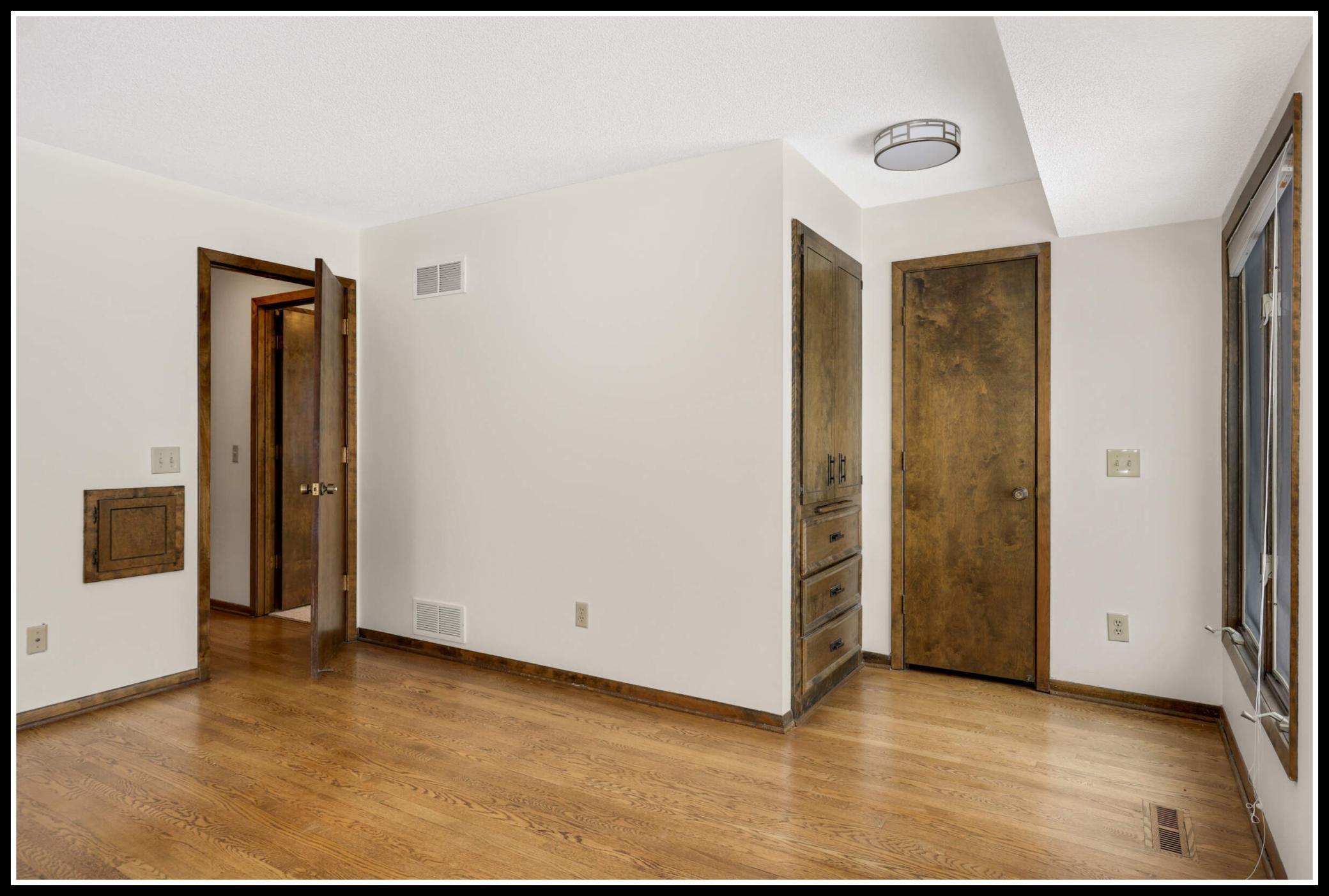 Primary suite includes built-in armoire and walk-in closet
