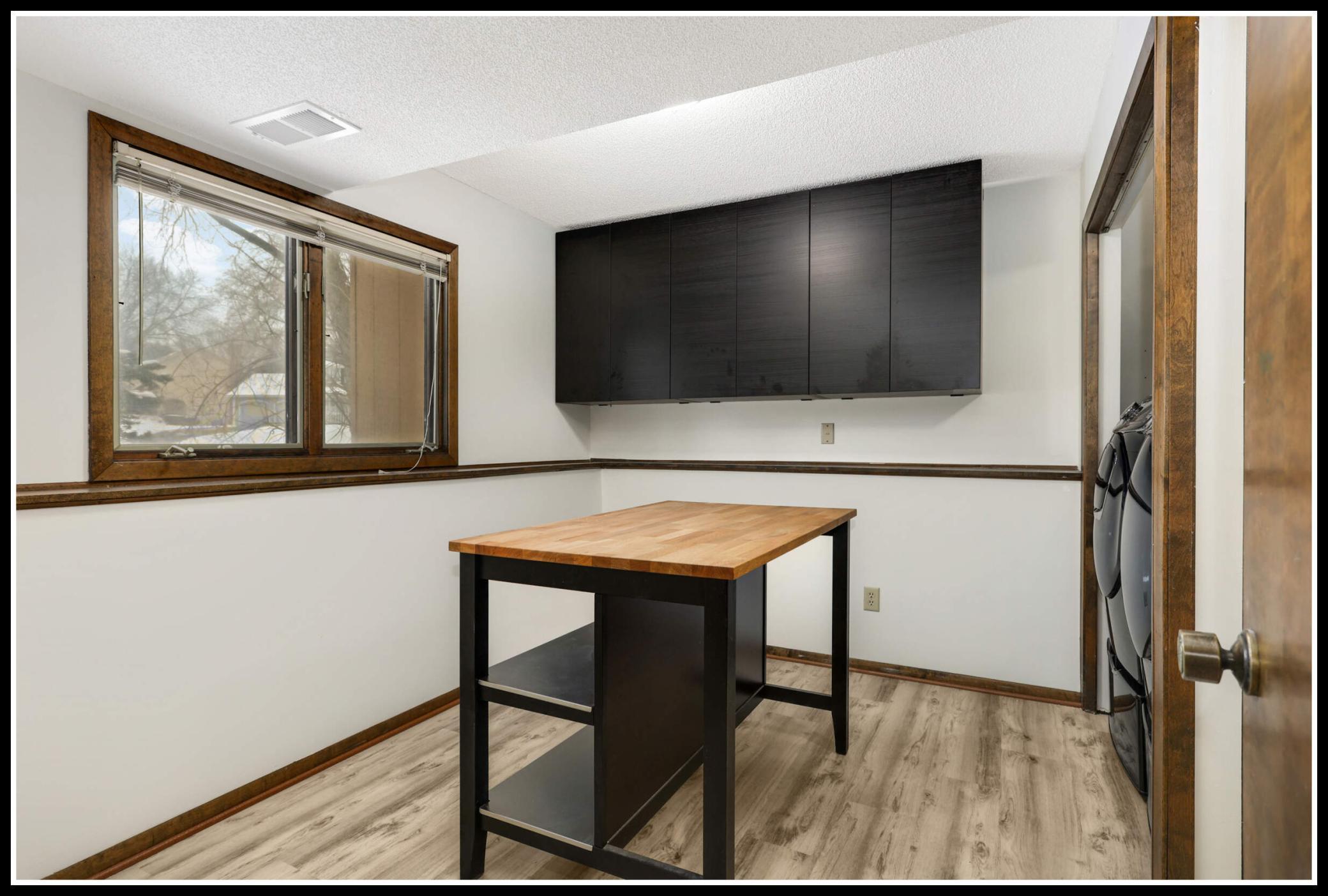 Third bedroom on the lower level, currently used as an epic laundry suite!