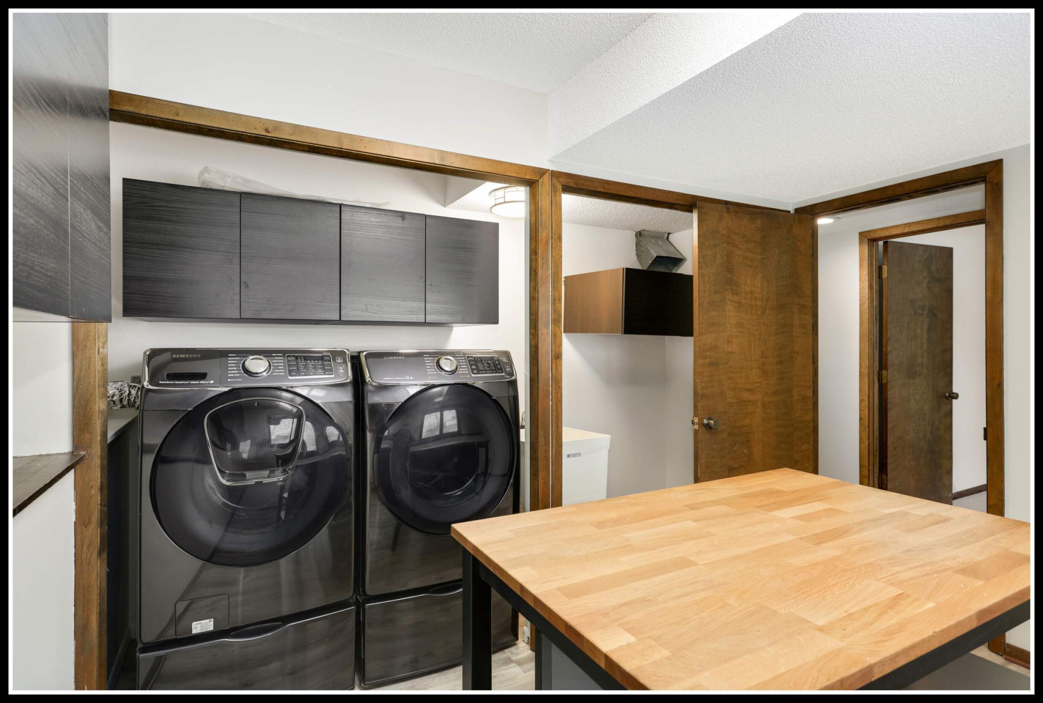 New washer and dryer can be closed behind closet doors to use the room for other purposes