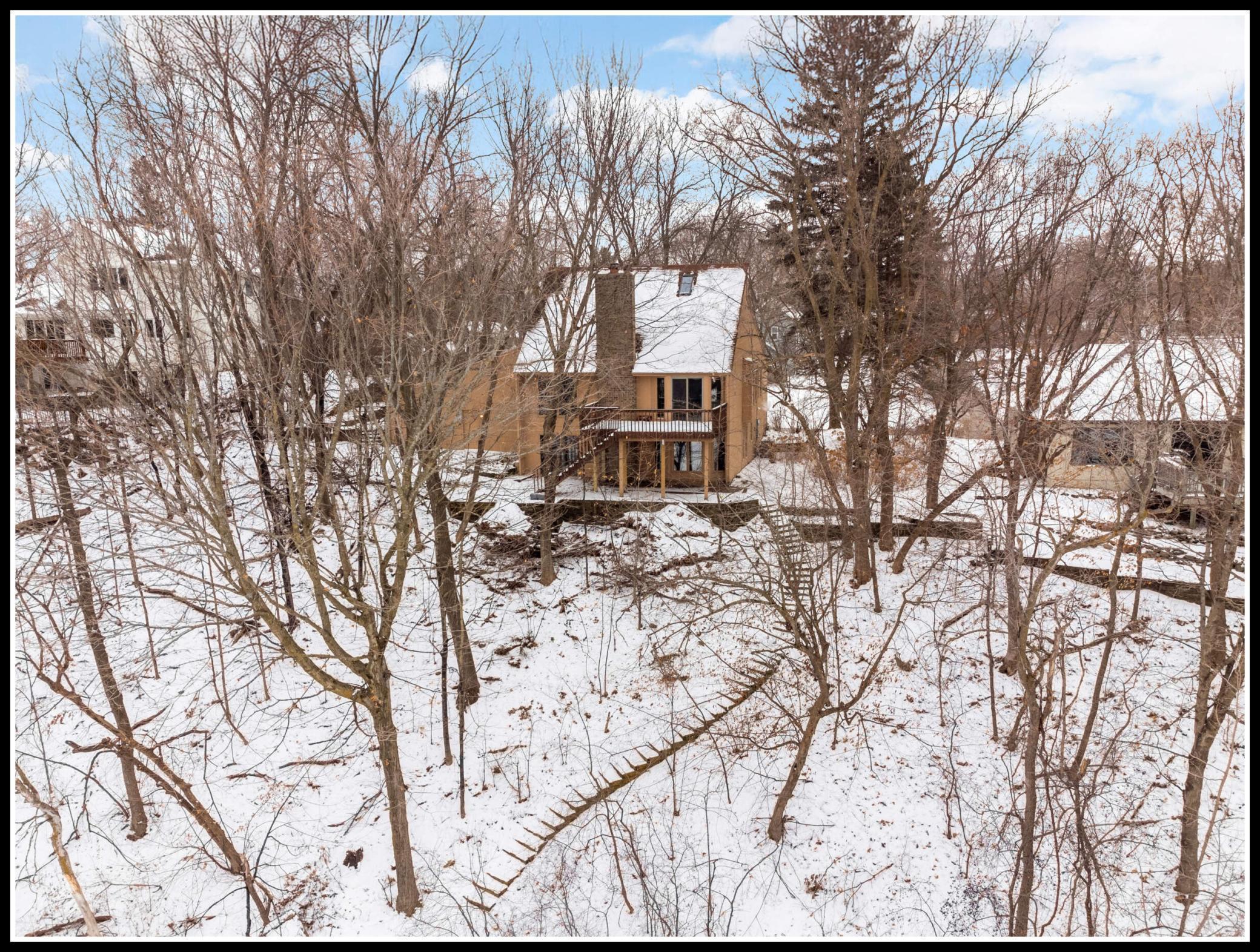 Heavily wooded lot with mature trees feels like your own peaceful "up North" retreat right in the heart of the suburbs