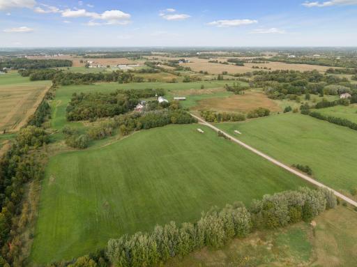 With over 60 acres, the home sits quietly on a heavily wooded homesite with peaceful surrounds and outbuildings. Unlimited potential to develop down the road or leave just the way it is and farm it.
