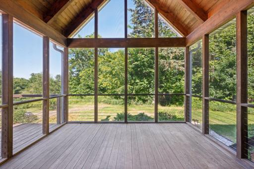 Screen porch with huge vaulted ceilings overlooks the pool and private acreage.