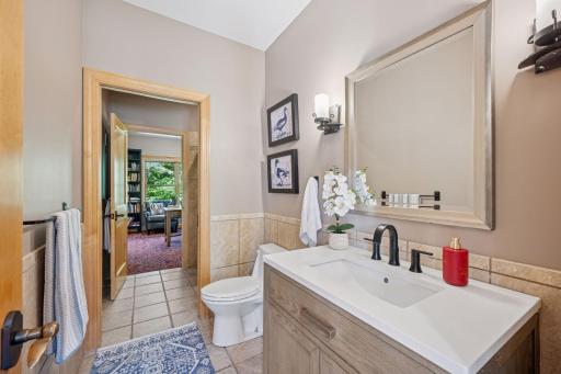 Main floor bathroom with ceramic tile floors and walk in shower.