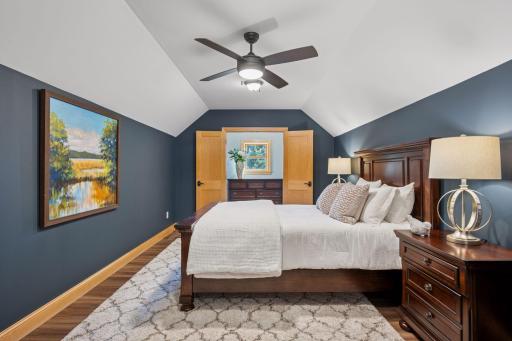 Primary suite with large walk in closet and vaulted ceiling.