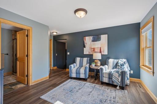 Primary suite features sitting area and 3/4 bathroom