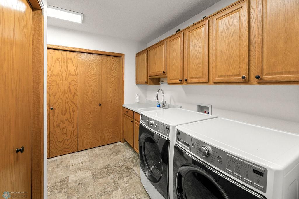 Laundry Room offers Storage cabinets, Closet, Utility Sink & Garage entry.