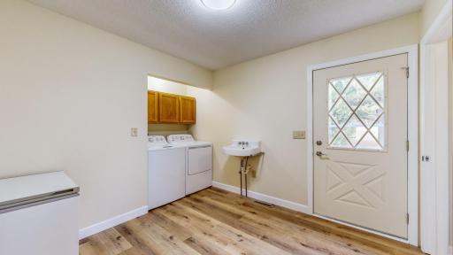 Photo for 609 Birch Street, Fountain, MN 55935 - Listing #6625335 Laundry area with door to backyard and steps to upper level to the right of the door