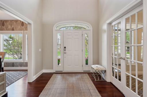 Gleaming NEWLY finished hardwood floors welcome you into the grand two story entryway.