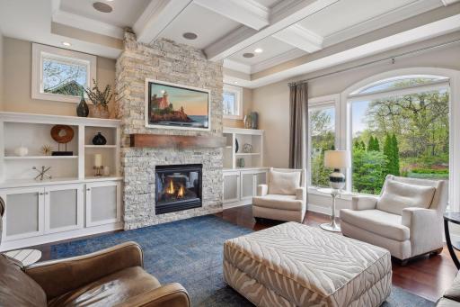Relax or entertain guests in this fully remodeled living room complete with newly finished hardwood floors, custom built ins, reclaimed wood mantel and coffered ceilings.