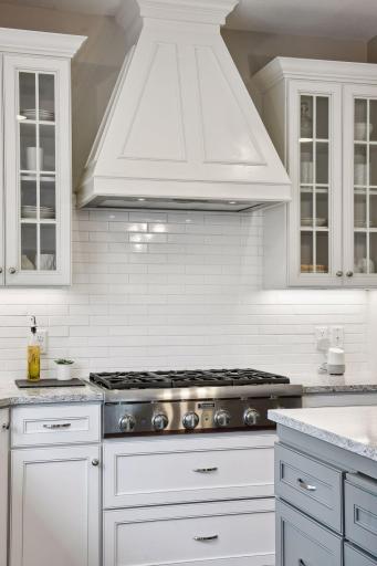 The full tile backsplash accents the Thermador Range.