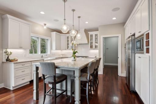 The well appointed kitchen has all of the upgrades including high end appliances, custom center island, double oven and quartz countertops.