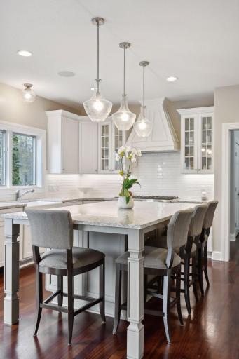 An oversized island is big enough for four and features gorgeous quartz countertops.