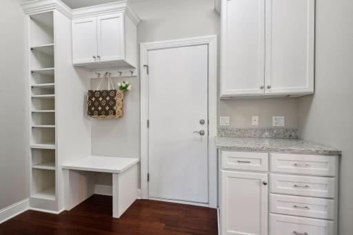The mudroom features ample storage, hooks and shelving for everyone.