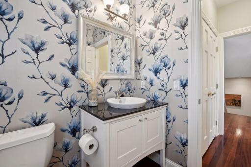 The main floor powder room is fully remodeled with fresh accents and a stand alone vanity.