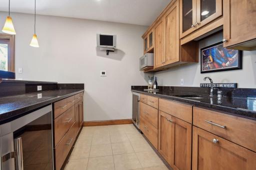 The full wet bar with a beverage fridge allows for easy entertaining.