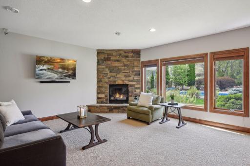 As you enter the basement, you will find a floor to ceiling fireplace with cozy stacked stone and an incredible view of the backyard.