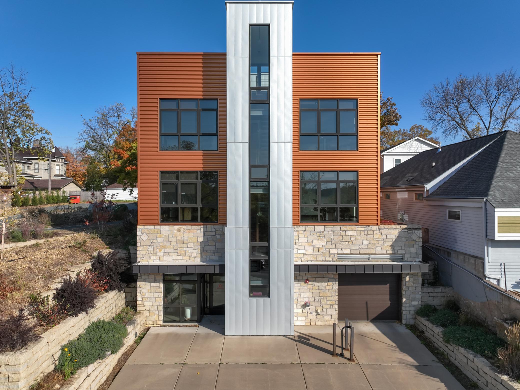 2nd St side of building, with front entry and entrance to parking ramp.