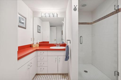 The lower-level bath has heated tile floors and a tiled shower - and a vintage feel.