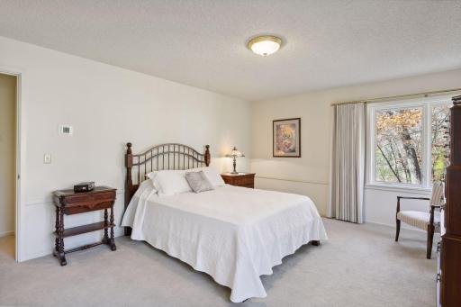 The guest bedrooms are spacious and have custom window treatments