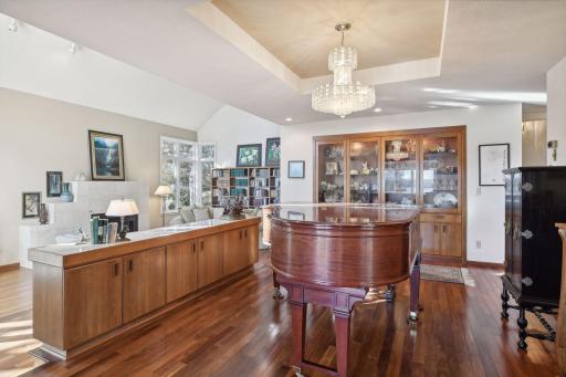 The dining room has a cove ceiling, spacious buffet and built-in china cabinet with lighting