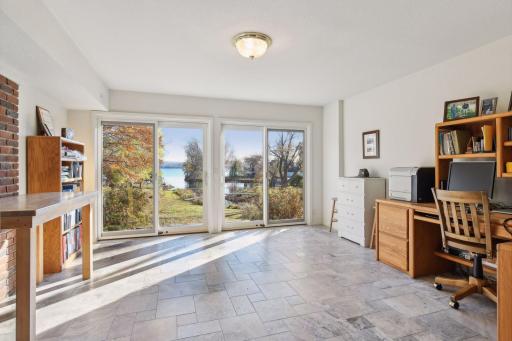The lower level sunroom has heated tile floors and is currently used as an office