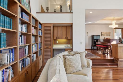 A wetbar with broom storage is tucked in the corner of the family room