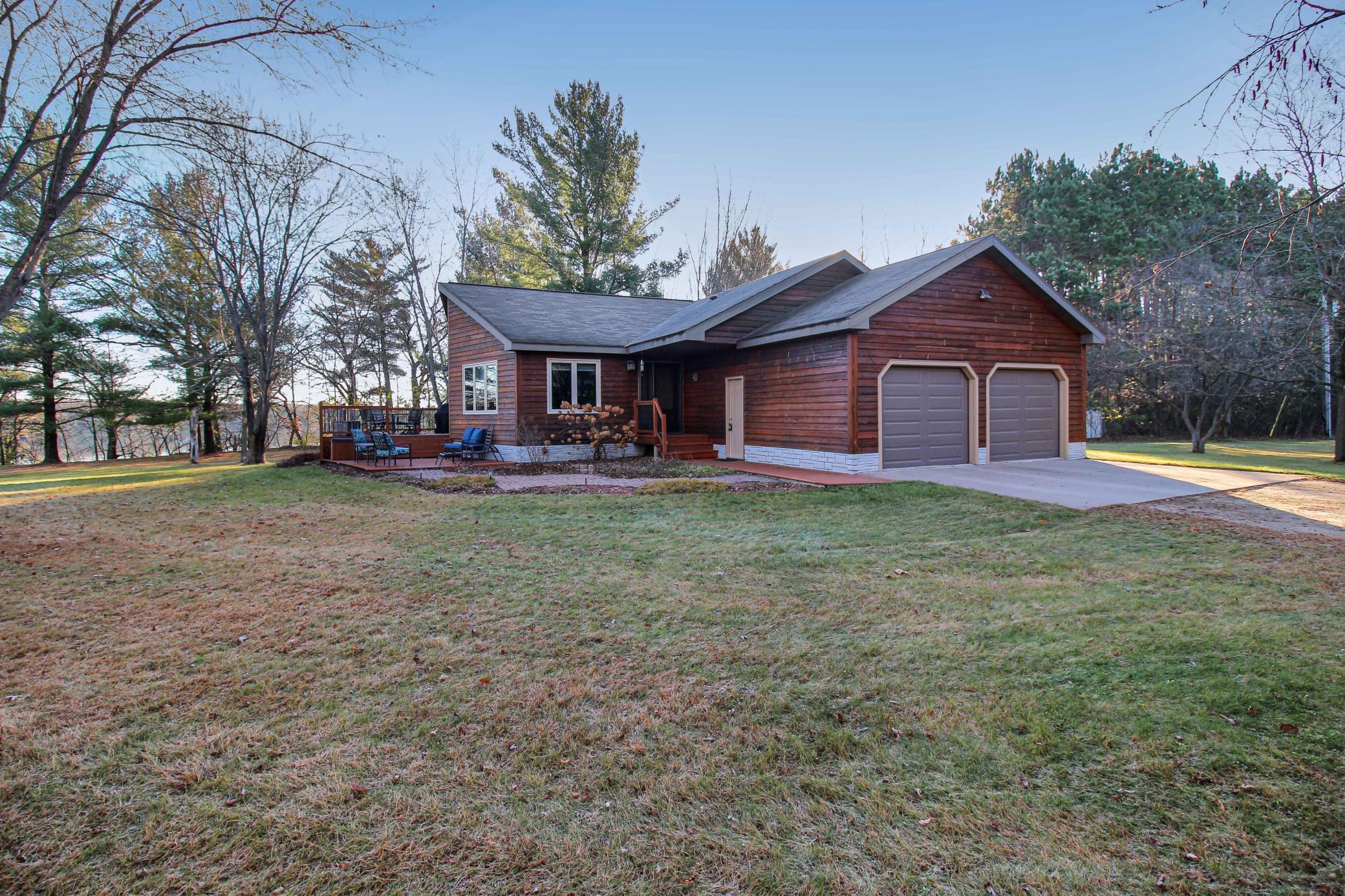 Front entry of the home, tucked within mature trees and backs up to the Mississippi River.jpg