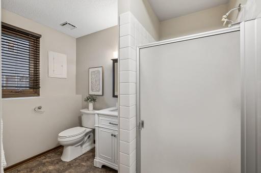 Functional & inviting lower level bathroom.