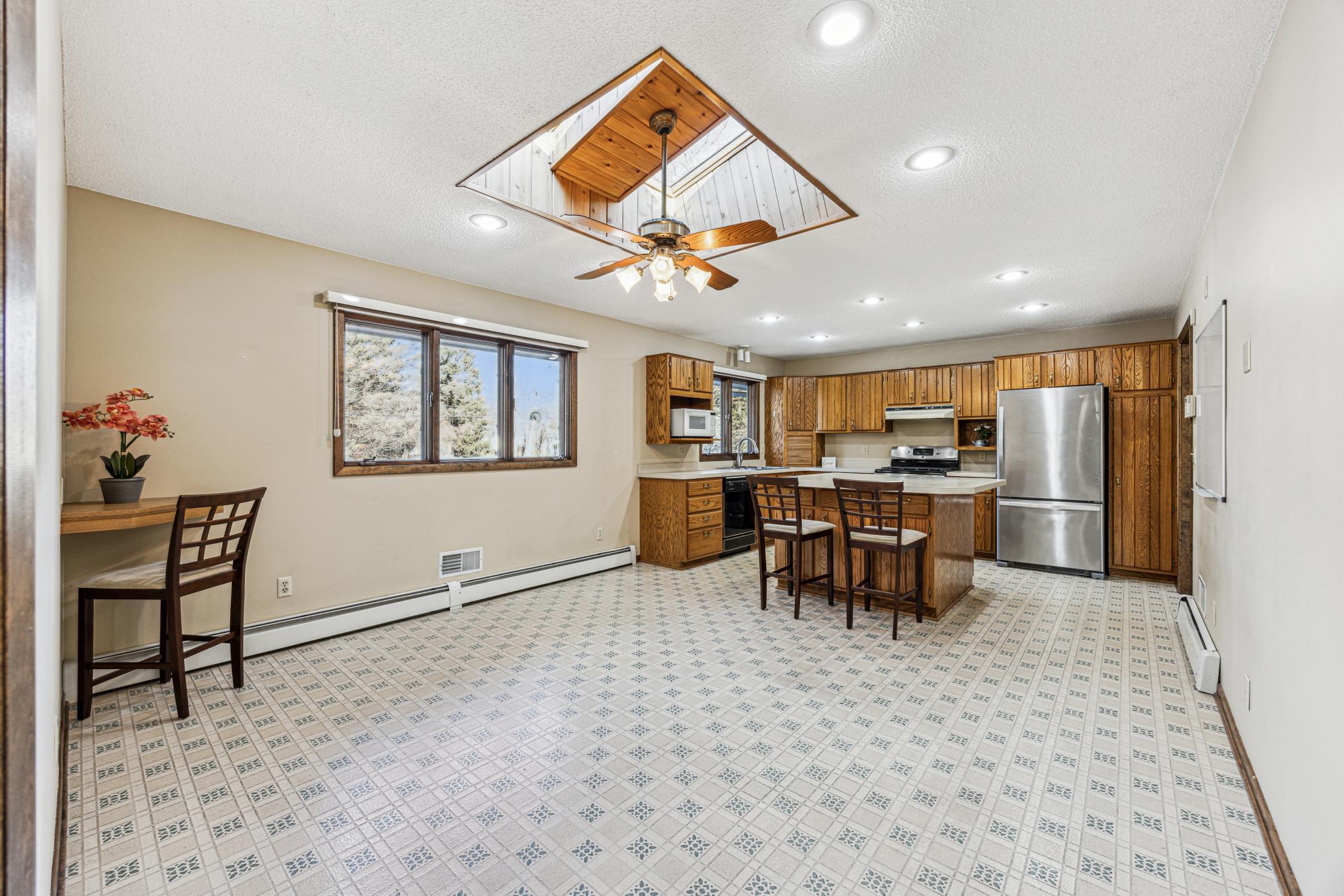 Large eat-in kitchen with skylights and center island.