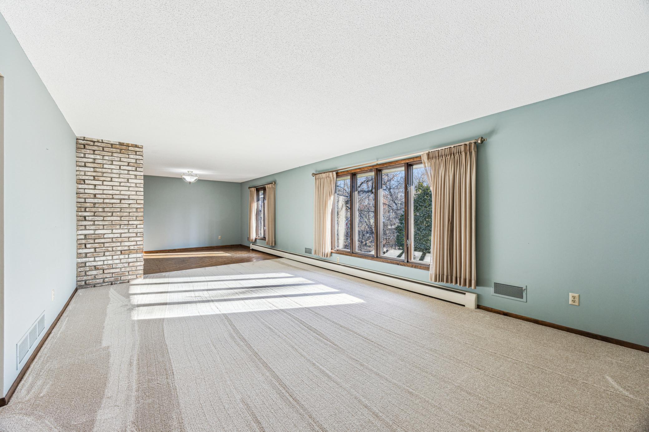 Sunny, open concept Living and Dining Rooms overlooking sunny back yard.