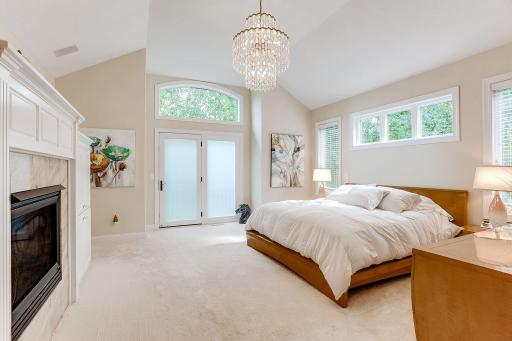 Owner's Suite with vaulted ceiling, gas fireplace, built-ins for media, and door to your future private deck.