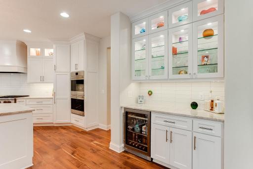 Wine fridge and bar prep area convenient to the kitchen. Two Large walk-in pantries near kitchen, the house is equipped with ample storage.