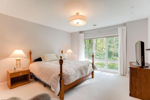 Bedroom 3 of the 3 lower level bedrooms. Floor to ceiling windows to take in the great views of the private backyard. All have oversized walk in closets. Jack and Jill full bath service two of the bedrooms.