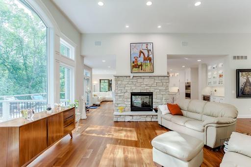 Two sided fireplace between the living room and the hearth room.