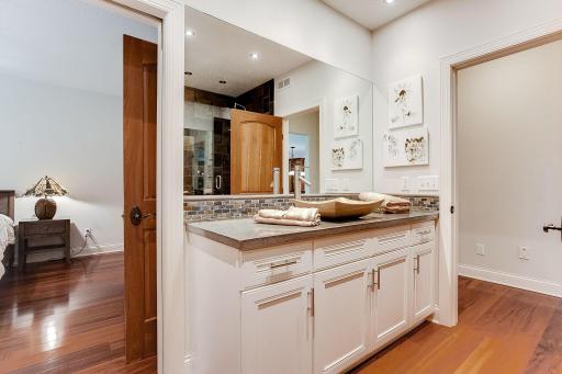 3/4 bath has a 6 person Aspen wood sauna and heated towel rack. Tigerwood flooring, concrete countertop and a vessel sink.