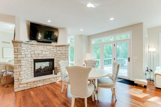 Informal Dining fireside with tv, adjoins hearth room and access to deck