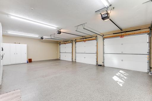Main 3 stall garage. Professional installed garage coating, 3 separate garage doors, floor drains and heated floors. Cabinets for lots of storage. Hot and cold soft water faucets for car washing, potting area.