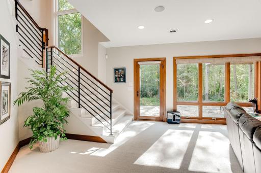Tons of natural light in the lower level with floor to ceiling windows. Open staircase and walk out to the patio. Natural cherry woodwork and gas fireplace.