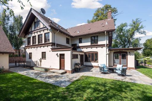 Private back yard with bluestone patio, easy access to the kitchen, access from a main level sunroom, garden beds, and grassy lawn. Full perimeter rail fencing.