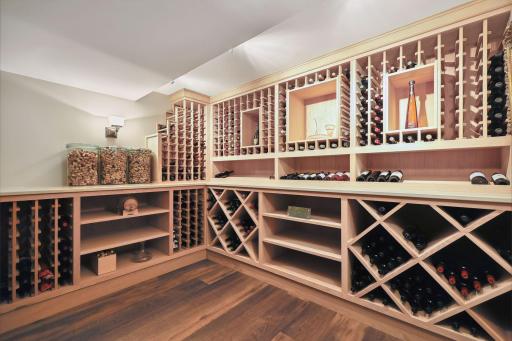 Temperature controlled custom wine room offers a beautiful wine collection display.